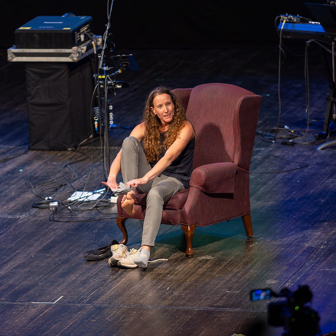 woman sitting in a chair on a stage