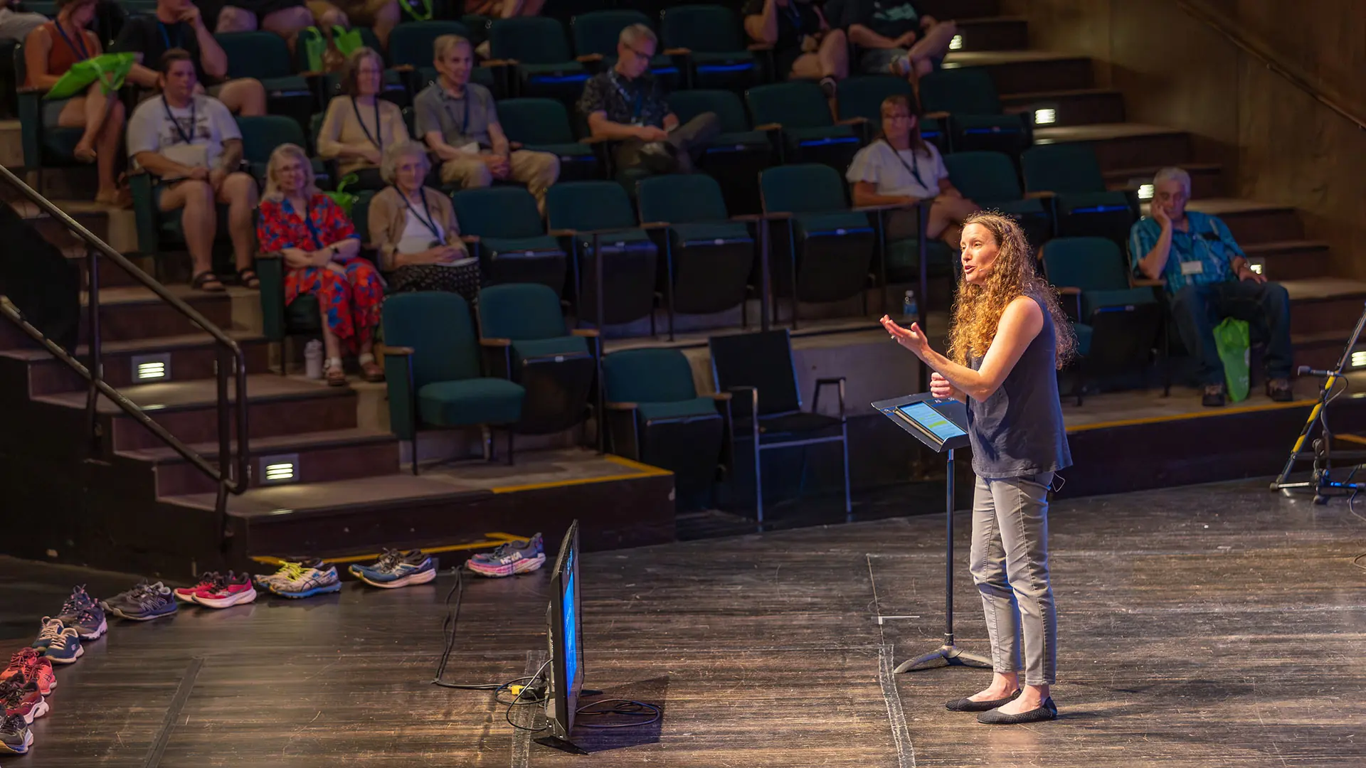 woman standing in front of a microphone on a stage