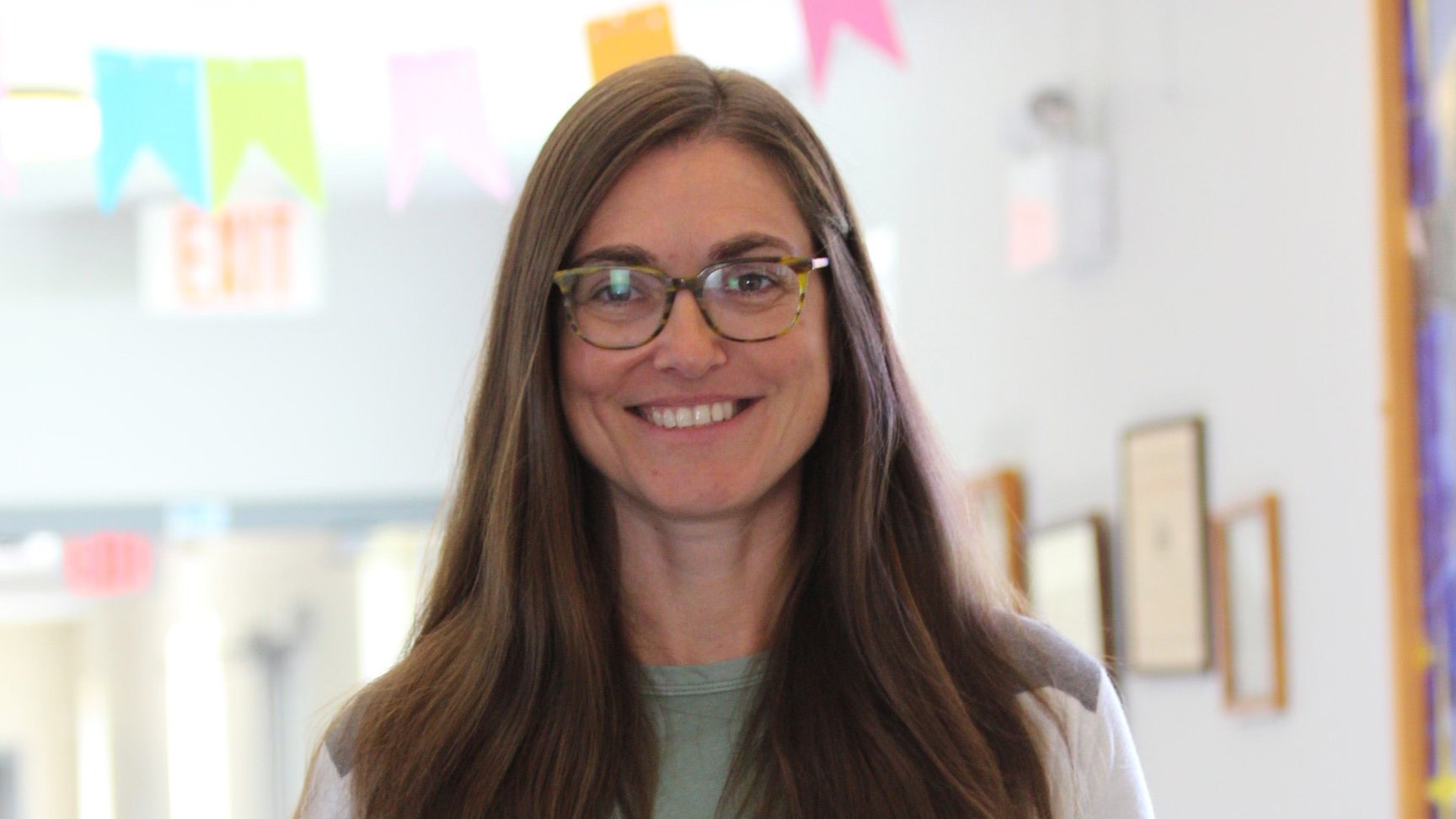 woman wearing glasses and a white coat
